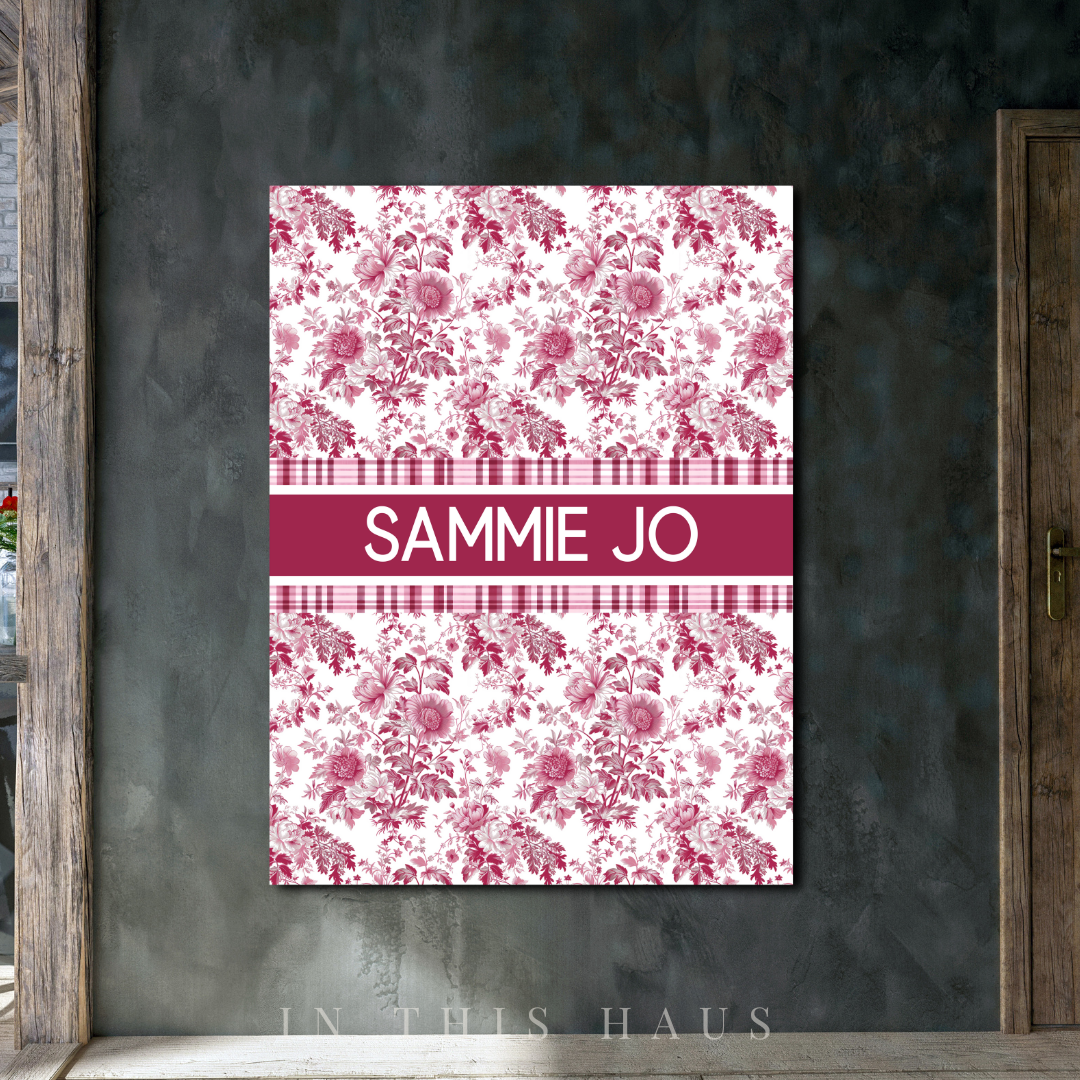 Personalized nursery wall decor with a floral and gingham design in pink tones