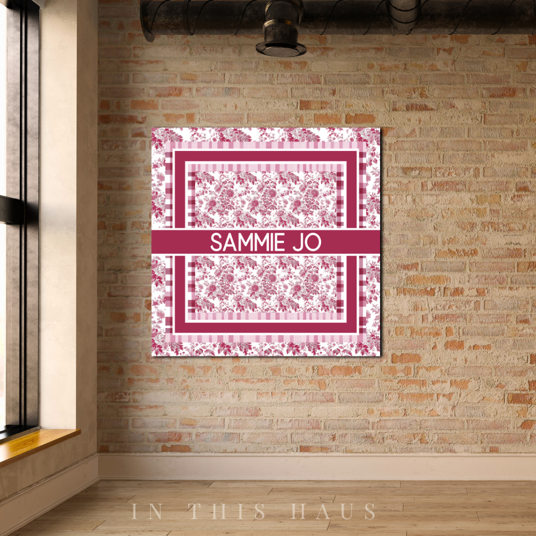 Close-up of the personalized name and soft pink tones on the toile canvas.