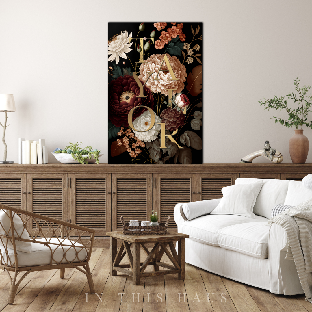 Dark and moody floral name sign with deep burgundy, blush, and ivory flowers on a canvas.