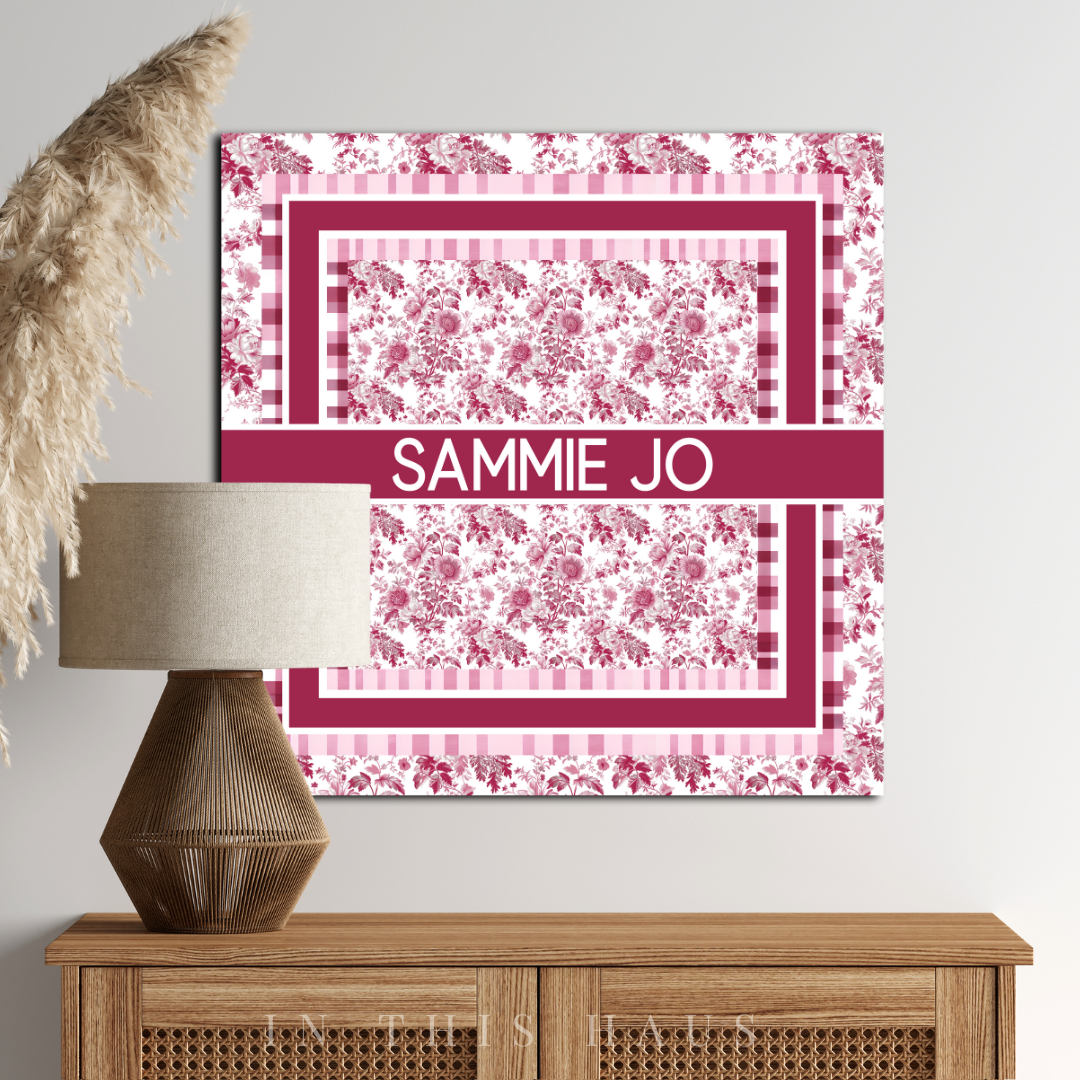 "Close-up of the intricate pink toile pattern and personalized text on the canvas."